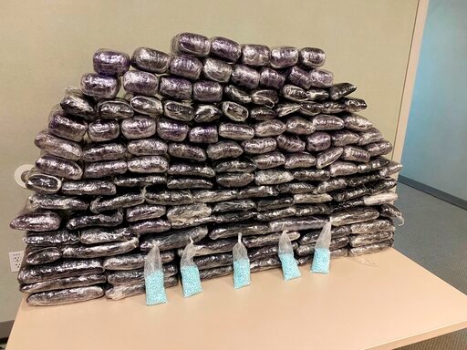This undated photo provided by the U.S. Drug Enforcement Administration, Los Angeles Field Division, shows some of the seized approximately 1 million fake pills containing fentanyl that were seized when agents served a search warrant, July 5, 2022, at a home in Inglewood, Calif. (DEA via AP)