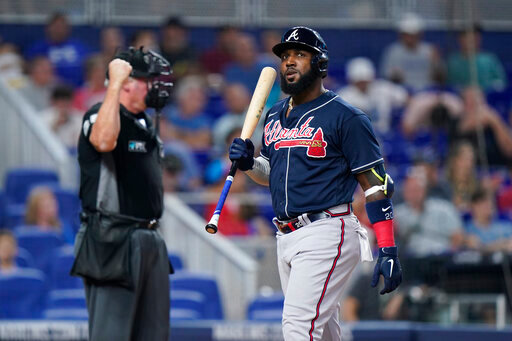 Atlanta Braves' Marcell Ozuna reacts after striking out during the seventh inning of a baseball game against the Miami Marlins, Sunday, Aug. 14, 2022, in Miami. (AP Photo/Wilfredo Lee)