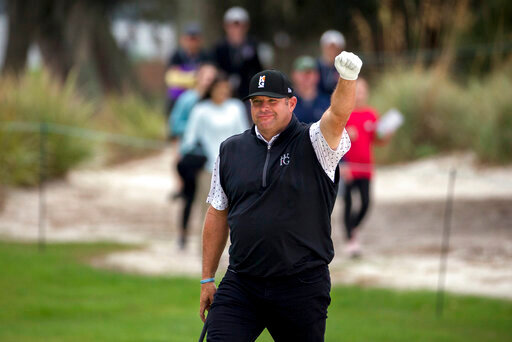 FILE - Jason Gore celebrates after hitting a birdie chip shot on the first green during the final round of the RSM Classic golf tournament on Nov. 18, 2018, in St. Simons Island, Ga. The tour announced Friday, Aug. 19, 2022, that it has hired Gore as a senior vice president and player adviser to the commissioner. (AP Photo/Stephen B. Morton, File)