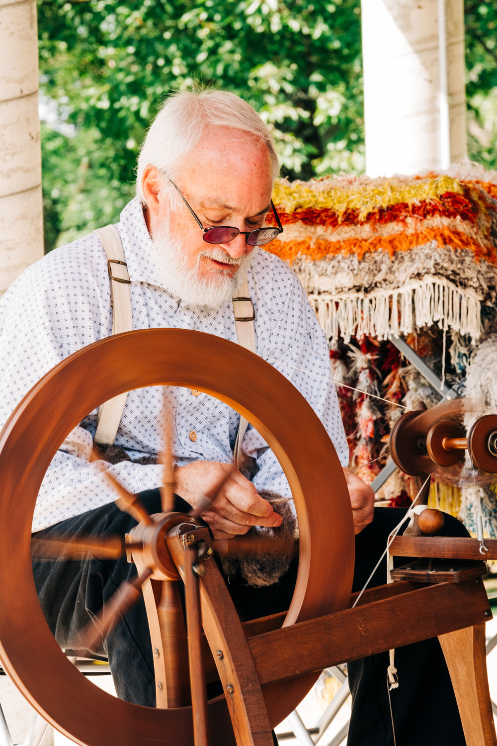 Tim Field spins wool at a demonstration during Little Balkans Days at the Crawford County History Museum on Saturday, Sept. 3.