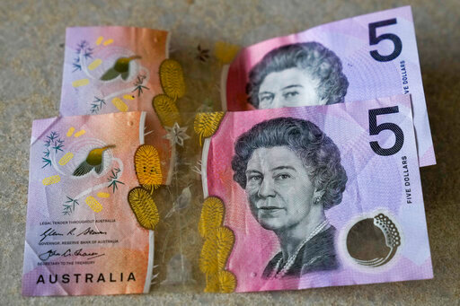 FILE - Australian $5 notes are pictured in Sydney, on Sept. 10, 2022. Many regarded Australians’ respect and affection for the late Queen Elizabeth II as the biggest obstacle to the country becoming a republic with its own head of state. Now after her death and with a pro-republic Labor Party government in power, Australia’s constitutional ties to the British monarchy will again be open to first-order debate for the first time since change was rejected at a 1999 referendum.(AP Photo/Mark Baker, File)