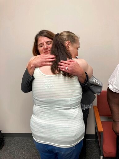 Dawn McIntosh hugs O'Fallon, Missouri, Detective Jodi Weber on Monday, Sept. 19, 2022, after a news conference announcing that a man has been charged for killing four women in the St. Louis area in 1990 in Clayton, Mo. McIntosh's mother, Donna Reiteyer, was one of the victims. Authorities say Gary Muehlberg, who is already in prison for an unrelated murder, has confessed to killing the women. Weber is credited with reopening the case. (AP Photo/Jim Salter)