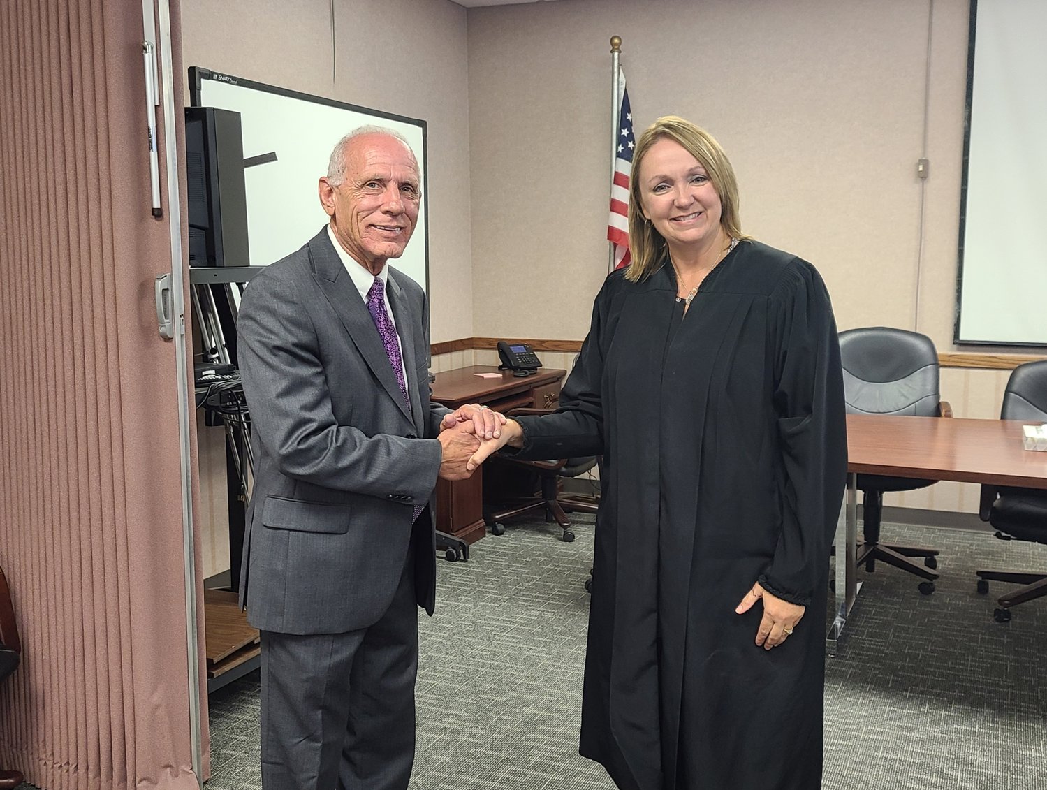 Chief Judge Lori Fleming, right, congratulates newly appointed magistrate judge Joe Gordon Gregory on his new position with the district.