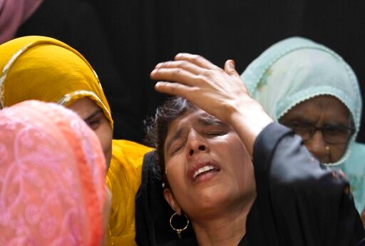 Relatives mourn by the body of Mohamed Usman, 15, who was killed by lightning on Friday at Prayagraj, in the northern Indian state of Uttar Pradesh, India. Saturday, Sept. 24, 2022. Hazardous weather killed at least 36 people in northern India over the past 24 hours, including 12 who died after being struck by lightning, officials said as they warned of more heavy downpours in the coming days. Usman was walking on a roof when he was struck by lightning. (AP Photo/Rajesh Kumar Singh)