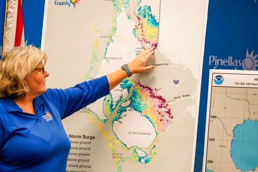 Emergency Management Director Cathie Perkins references a map indicating where storm surge would impact the county, urging anyone living in those areas to evacuate, during a press conference regarding Hurricane Ian at the Pinellas County Emergency Operations Center, Monday, Sept. 26, 2022 in Largo, Fla. Hurricane Ian was growing stronger as it approached the western tip of Cuba on a track to hit the west coast of Florida as a major hurricane as early as Wednesday. (Martha Asencio-Rhine/Tampa Bay Times via AP)