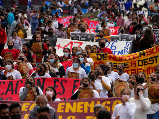 Relatives and classmates of the missing 43 Ayotzinapa college students and their supporters march in Mexico City, Monday, Sept. 26, 2022, on the day of the anniversary of the disappearance of the students in Iguala, Guerrero state. Three members of the military and a former federal attorney general were recently arrested in the case, and few now believe the government's initial claim that a local drug gang and allied local officials were wholly to blame for seizing and killing the students on July 26, 2014, most of which have never been found. (AP Photo/Marco Ugarte)