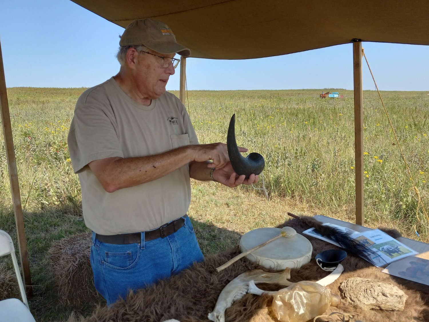 Galen Ewing, seasonal park naturalist, demonstrates how a bison horn can be used to hold gunpowder.