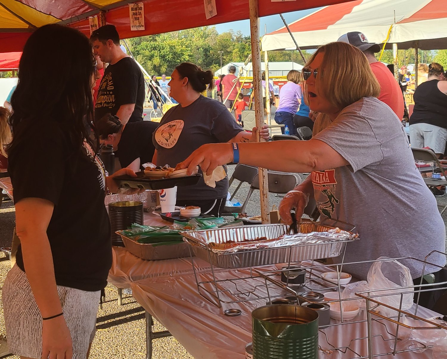 Janelle Pyle, one of the volunteer cooks, serves pasta at the annual Festa Italiana on Saturday.