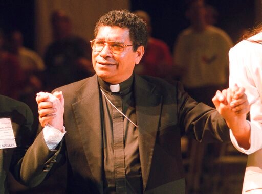 FILE - Bishop Carlos Ximenes Belo of East Timor, sings along with participants at the National Catholic Gathering for Jubilee Justice held on the UCLA Campus in Los Angeles, on July 17, 1999. Belo has been accused in a Dutch magazine article of sexually abusing boys in East Timor in the 1990s, rocking the Catholic Church in the impoverished nation and forcing officials at the Vatican and his religious order to scramble to provide answers. (AP Photo/Neil Jacobs, File)