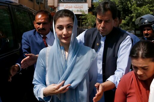 FILE - Maryam Nawaz, center, daughter of former Prime Minister Nawaz Sharif arrives with her husband Muhammad Safdar, second right, to appear in a court, in Islamabad, Pakistan, Wednesday, Sept. 23, 2020. A court in Pakistan's capital city on Thursday, Sept. 29, 2022, acquitted the daughter of former Prime Minister Nawaz Sharif, four years after she was sentenced to seven years in prison over purchases of luxury apartments in London. (AP Photo/Anjum Naveed, File)