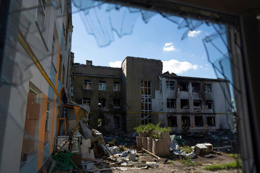A view of a school which was used as a Russian military base in the recently liberated town of Izium, Ukraine, Wednesday, Sept. 21, 2022. Dozens of Ukrainian children are trapped by shifting frontlines in Russian summer camp. Fifty-two children from Izium and at least 50 more from other towns in the Kharkiv region, all between the ages of 9 and 16, are now scattered in camps. (AP Photo/Evgeniy Maloletka)