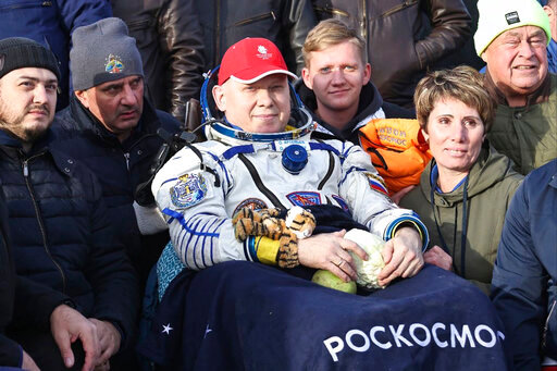 In this image distributed by Roscosmos State Space Corporation, Russian cosmonaut Oleg Artemyev sits in the chair shortly after the landing of the Russian Soyuz MS-21 space capsule southeast of the Kazakh town of Zhezkazgan, Kazakhstan, Thursday, Sept. 29, 2022. Three Russian cosmonauts returned safely from a mission to the International Space Station. The Soyuz MS-21 spacecraft carrying Oleg Artemyev, Denis Matveyev and Sergey Korsakov touched down softly at 4:57 p.m. (1057 GMT) Thursday at a designated site in the steppes of Kazakstan about 150 kilometers (about 90 miles) southeast of the city of Zhezkazgan. (Pavel Kassin, Roscosmos State Space Corporation via AP)