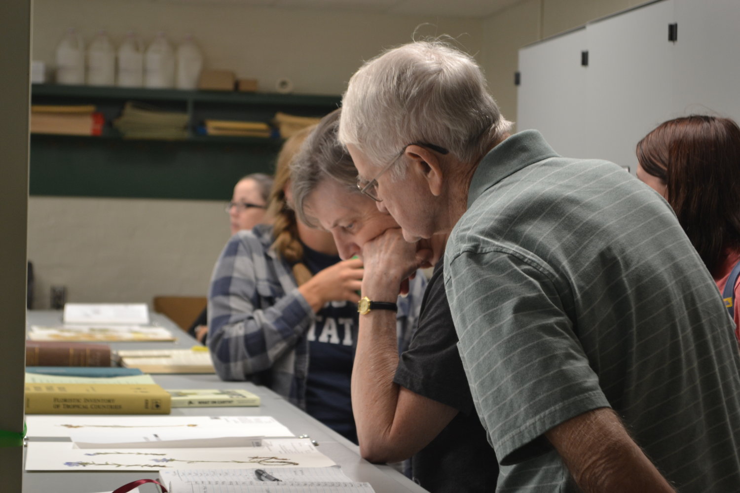 Local residents Diana Brooks, left, and Burl Brooks look at some of the featured plants during the Sperry Herbarium Open House in Hartman Hall at Pittsburg State University on Friday.