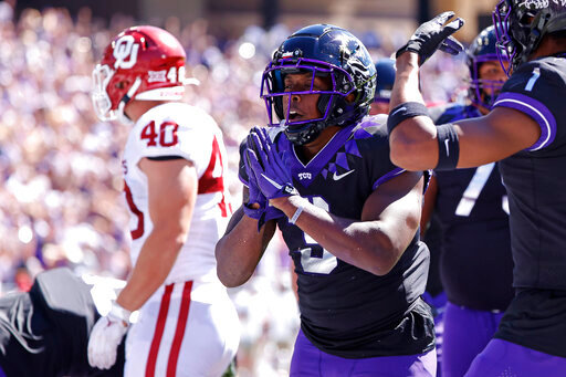 TCU running back Emari Demercado (3) celebrates with teammates after running for a touchdown against Oklahoma during the first half of an NCAA college football game Saturday, Oct. 1, 2022, in Fort Worth, Texas. (AP Photo/Ron Jenkins)