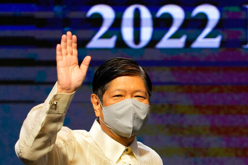 Philippine President Ferdinand Marcos Jr. waves as he arrives at the 2022 Department of Environment and Natural Resources Multistakeholder Forum in Manila, Philippines, Wednesday, Oct. 5, 2022. Marcos Jr. has reaffirmed ties with the United States, the first major power he visited since taking office in June, in a key turnaround from the often-hostile demeanor his predecessor displayed toward Manila's treaty ally. (AP Photo/Aaron Favila)