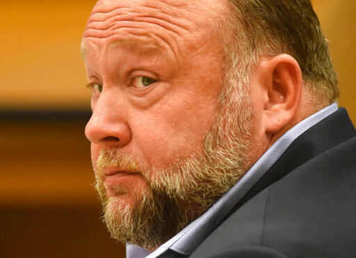 FILE - Infowars founder Alex Jones appears in court to testify during the Sandy Hook defamation damages trial at Connecticut Superior Court in Waterbury, Conn., on Thursday, Sept. 22, 2022. A six-person jury reached a verdict Wednesday, Oct. 12, 2022, saying that Jones should pay $965 million to 15 plaintiffs who suffered from his lies about the Sandy Hook school massacre. Jones and his company were found liable for damages last year. (Tyler Sizemore/Hearst Connecticut Media via AP, Pool, File)