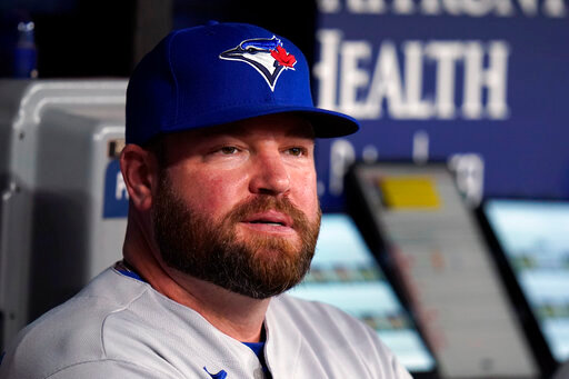 FILE - Toronto Blue Jays interim manager John Schneider looks on from the dugout during the first inning of a baseball game against the Tampa Bay Rays, Thursday, Sept. 22, 2022, in St. Petersburg, Fla. The Blue Jays rewarded Schneider for his strong performance as their interim manager, agreeing to terms with him Friday, Oct. 21, 2022, on a new contract. Schneider agreed to a three-year deal as manager with a team option for 2026, the Blue Jays said. (AP Photo/Chris O'Meara, File)