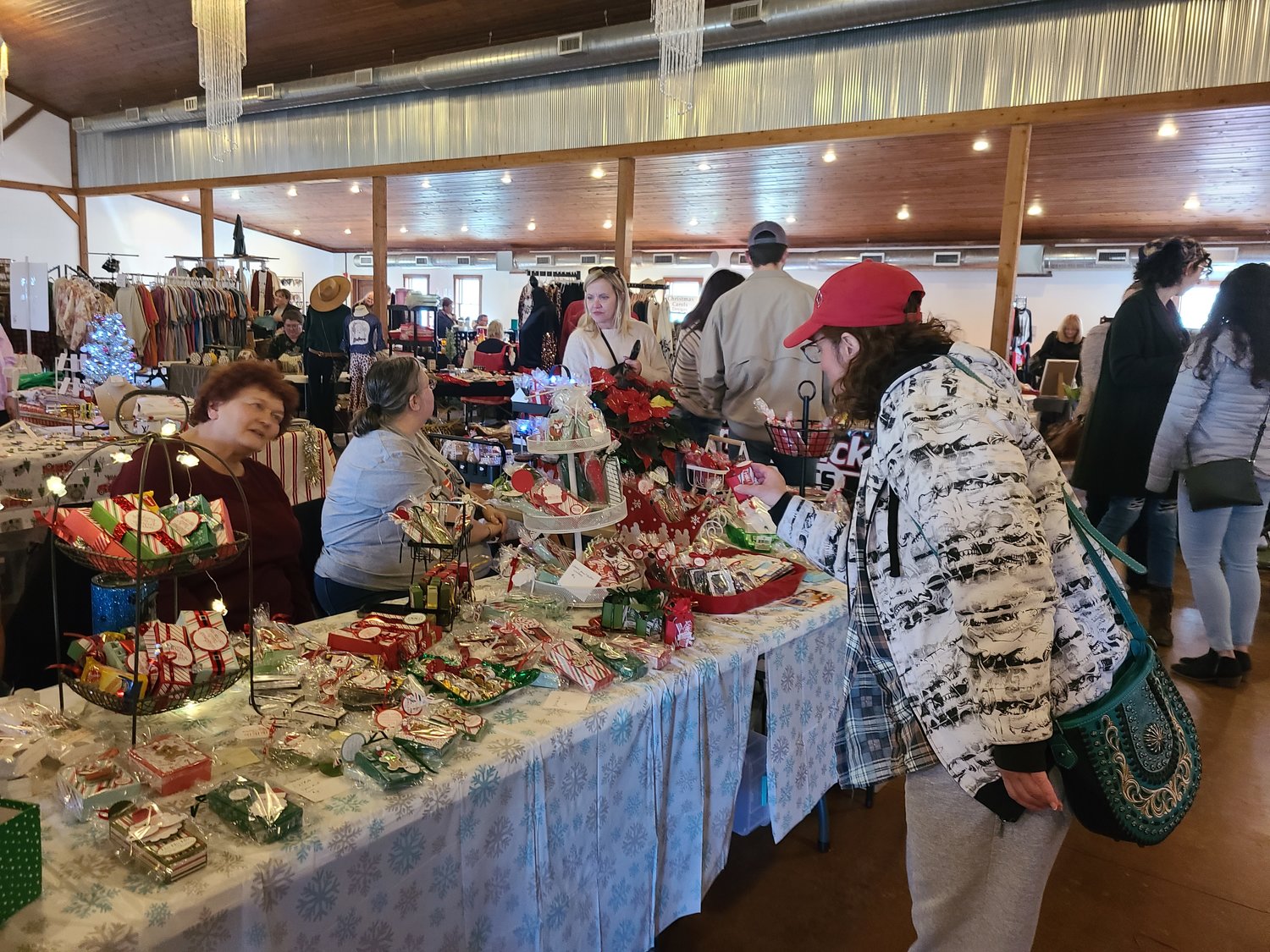 Buyers bustled to the Barn at Timber Cove to shop for Christmas must-haves at the annual Holiday Market on Saturday. Crafters and makers offered a selection of items ranging from fruit wine to handmade ornaments, t-shirts, bath products, dolls, baked goods, jewelry and much more.