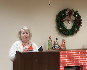 Local author Olive Sullivan reads from her newly released book of poetry “Skiving Down the Bones” at her event at the Pittsburg Public Library on Monday evening. Sulivan had her new book and previously released books available for purchase and she signed each one.
