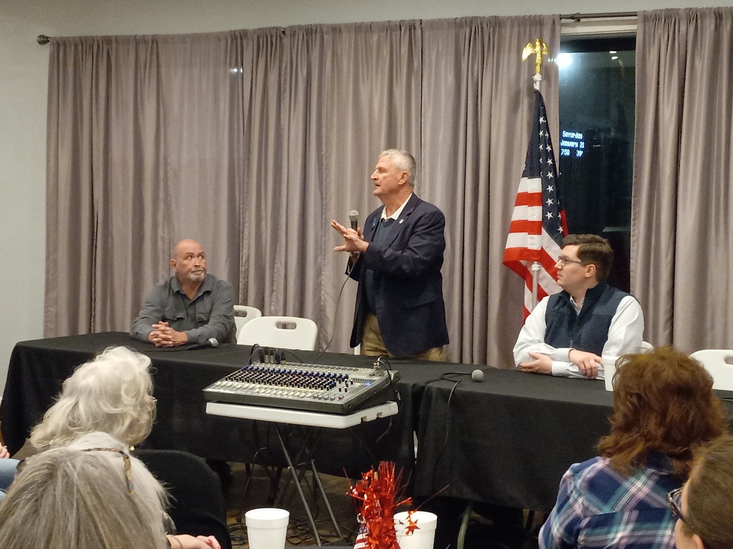 Rep. Chuck Smith, standing, speaks during a panel discussion alongside Rep. Ken Collins, left, and Congressman Jake LaTurner, right, at Saturday’s GOP event at Palluccas Event Hall.