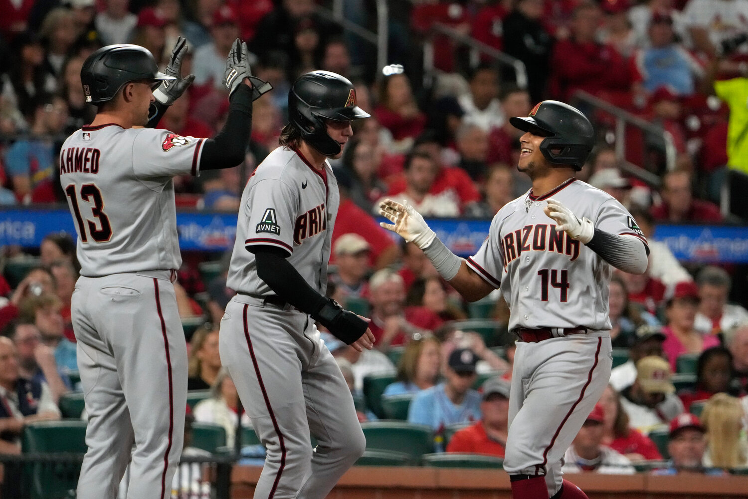 Arizona Diamondbacks' Gabriel Moreno (14) is congratulated by teammates Jake McCarthy and Nick Ahmed (13) after hitting a three-run home run during the fourth inning of their game against the St. Louis Cardinals on Tuesday in St. Louis. (AP Photo/Jeff Roberson)