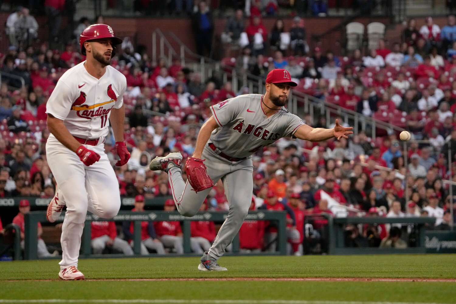 Los Angeles Angels starting pitcher Patrick Sandoval, right, throws out St. Louis Cardinals' Paul DeJong at first to end the second inning of a baseball game Tuesday, May 2, 2023, in St. Louis. (AP Photo/Jeff Roberson)