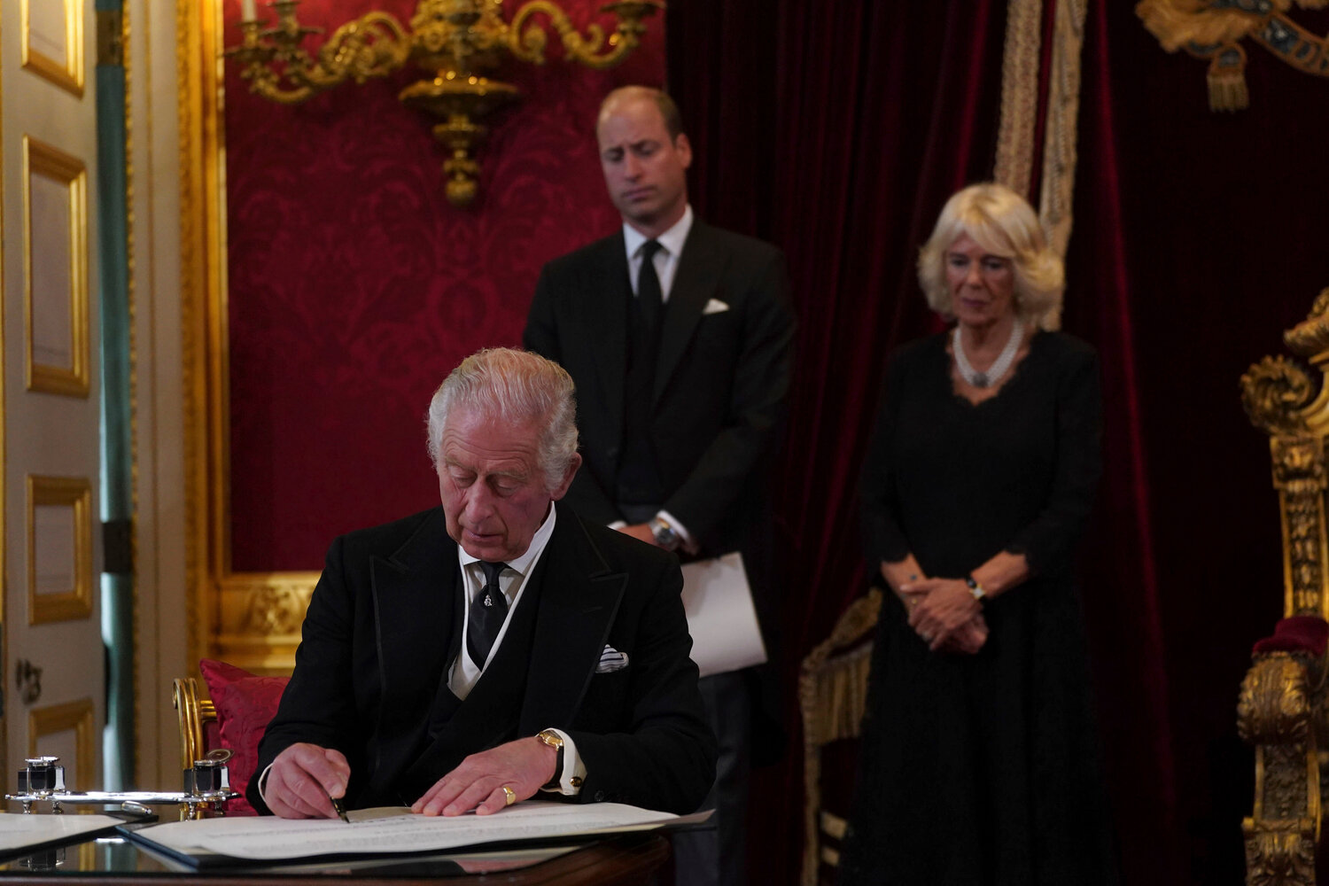 FILE - Britain's King Charles III signs an oath to uphold the security of the Church in Scotland during the Accession Council at St James's Palace, London, Saturday, Sept. 10, 2022, where he was formally proclaimed monarch. Charles automatically ascended to the throne when Elizabeth died Sept. 8 and he was officially proclaimed Britainâs monarch two days later in an ascension ceremony broadcast for the first time on television. (Victoria Jones/Pool Photo via AP, File)