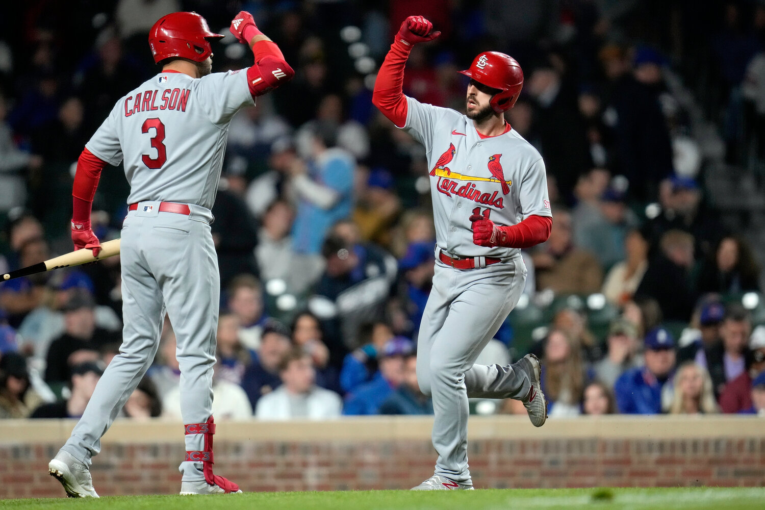St. Louis Cardinals' Paul DeJong (right) celebrates his home run with Dylan Carlson during the ninth inning of Tuesday night's game against the Chicago Cubs in Chicago. (AP Photo/Erin Hooley)