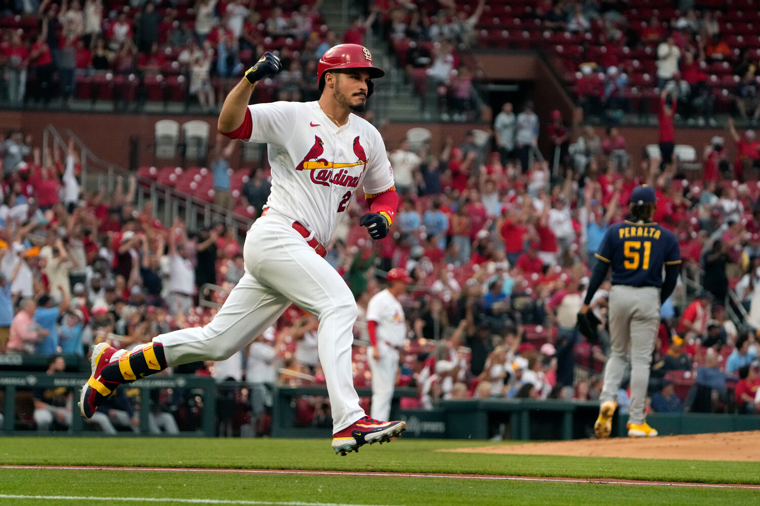 St. Louis Cardinals' Nolan Arenado, left, celebrates as he rounds the bases after hitting a three-run home run off Milwaukee Brewers starting pitcher Freddy Peralta (51) during the first inning of a baseball game Monday, May 15, 2023, in St. Louis. (AP Photo/Jeff Roberson)