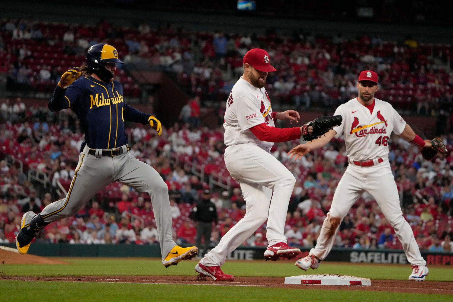 Milwaukee Brewers' Brice Turang (left) is out at first by St. Louis Cardinals starting pitcher Jordan Montgomery as first baseman Paul Goldschmidt watches during their game Tuesday night in St. Louis. (AP Photo/Jeff Roberson)