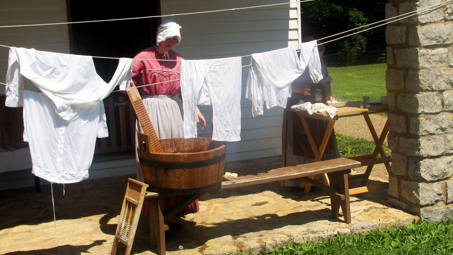 A volunteer dressed as a laundress leads a demonstration for visitors at the Fort Scott National Historic Site.
