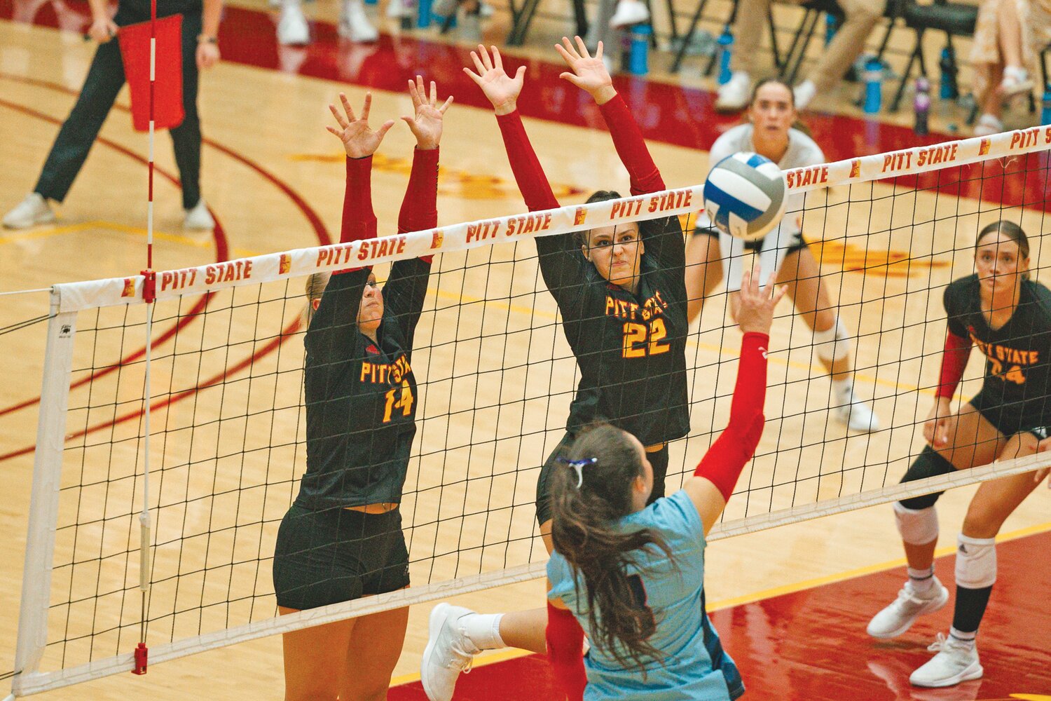 Pittsburg State’s Jadyn Jackson (14) and Carly Clennan go up for a block against Newman in Tuesday night’s match at John Lance Arena.