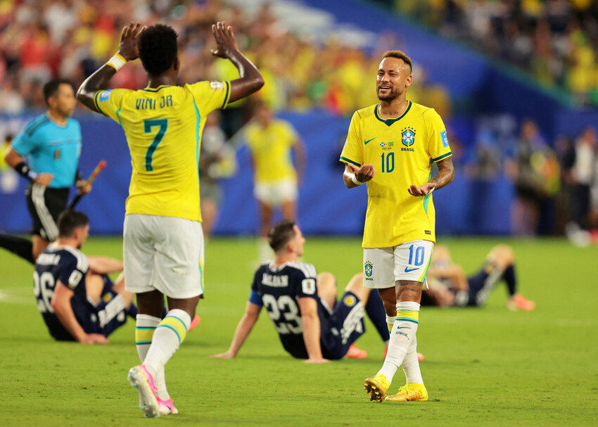 Brazil's Neymar Jr. celebrates after the match with Vinicius Junior