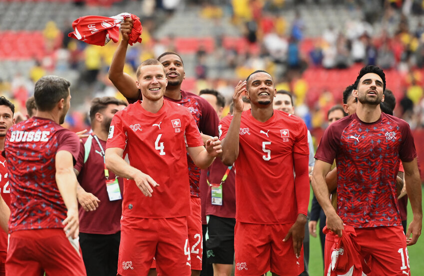 Switzerland's Nico Elvedi, Manuel Akanji and Eray Comert celebrate after the penalty shootout as Switzerland qualify for the quarter finals of the World Cup