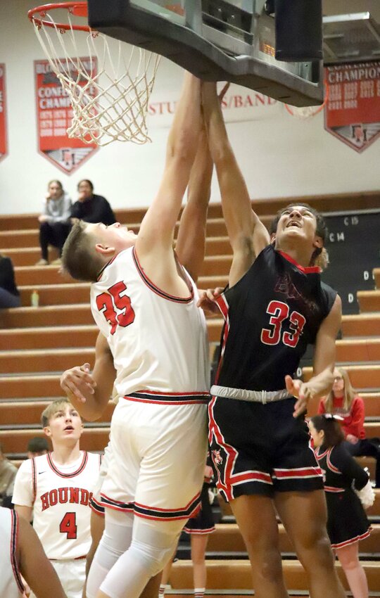 Senior Hunter Cresswell goes up to block a shot by Williamsburg's Kellen Cockrell in the first period Saturday afternoon. Fort Madison would fall 61-57 in double overtime.