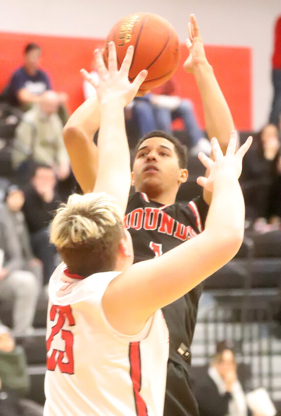 Fort Madison junior Julian Dear goes up for the shot in the third quarter of Monday's loss to Williamsburg. The loss ended the season for the Bloodhounds.