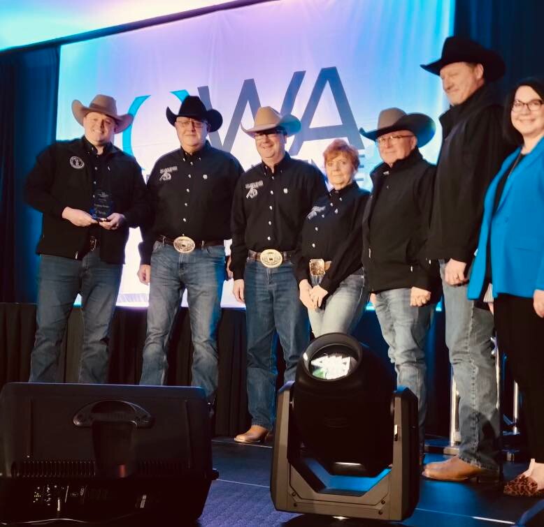 Representatives of the Tri State Rodeo are presented the Outstanding Event award at the Iowa Tourism Conference last week in Des Moines.