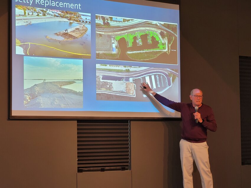 Fort Madison Mayor Matt Mohrfeld points to some before and after photos of the Fort Madison marina with the new facility open for business.