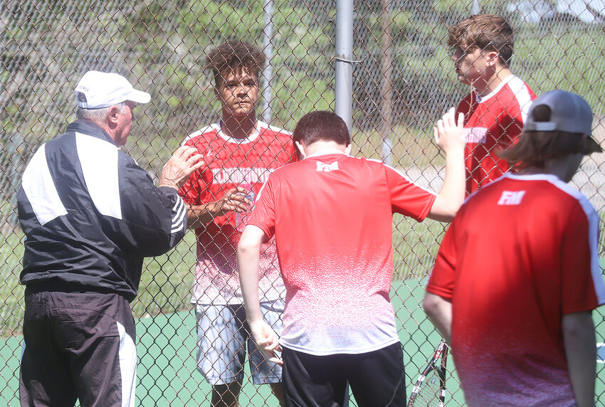 Fort Madison Head boys tennis coach Dean Hogan talks with Bloodhounds Javean Davis and Aiden Benda before a tiebreaker set Wednesday at the Southeast Conference Invitational in Burlington.