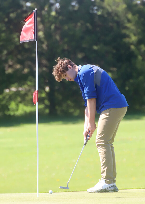 Holy Trinity junior Luke Hellige putts for a par on Hole 14 Wednesday during the SEI Superconference boys' golf tournament at Sheaffer Memorial Golf Course in Fort Madison.