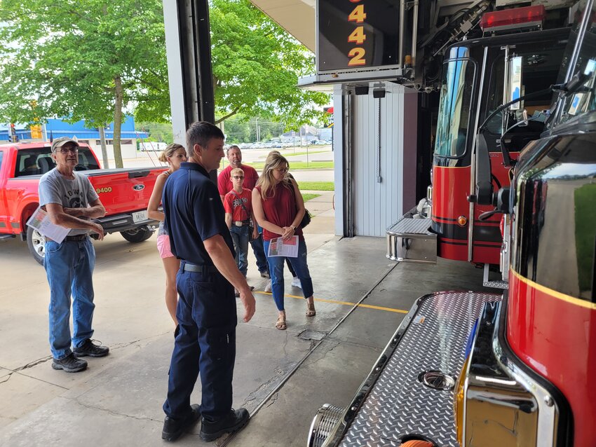 Firefighter John Lange talks with some visitors on the front side of the firehouse early Wednesday during an open house. The department held the open house to show residents the condition of the current facility.