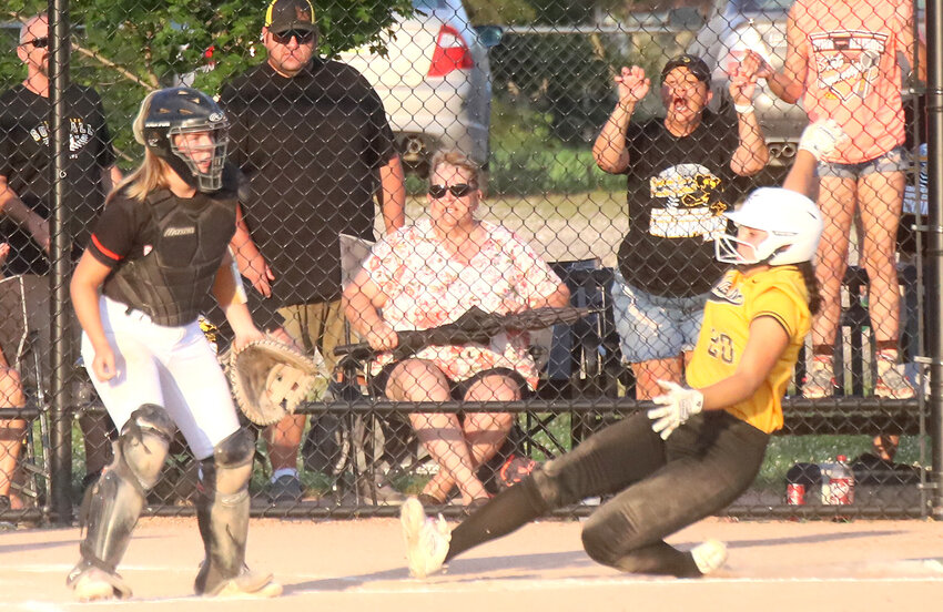 The Lady Hawks' Kenna Sandoval scores the first run of the game Saturday in the Class 3A Region 8 semifinal game at Washington. The Hawks would win the game scoring four runs in the top of the seventh inning to advance to Tuesday's regional final at Davenport Assumption.