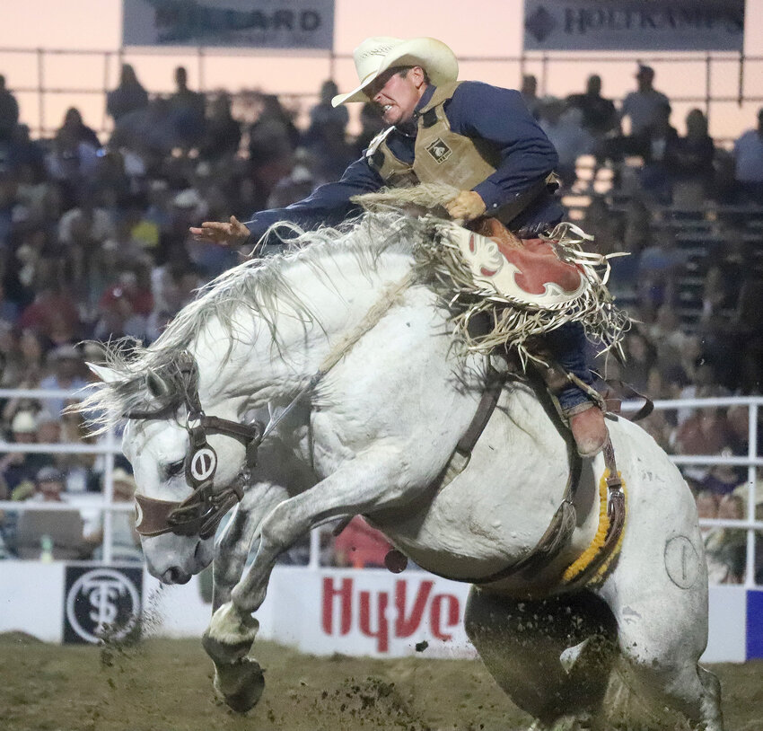 A Saddle Bronc Riider sits for the full eight seconds on a hard ride Wednesday at the Jim Baier Chute Out in Fort Madison kicking off professional cowboy action at the Tri-State Rodeo.