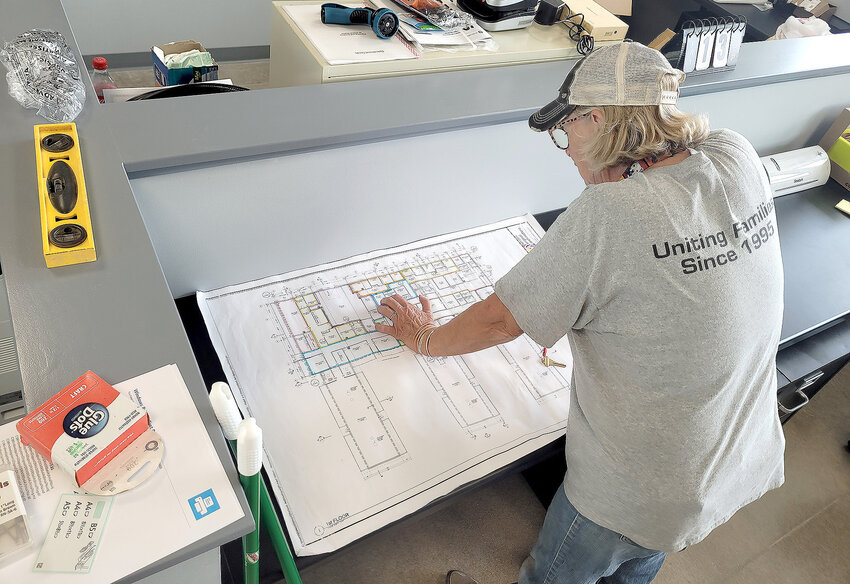 Sandy Brown, the director of the P.A.W. animal shelter, looks over blueprints of the new shelter on 48th Street in Fort Madison. Animals were being moved into the new digs over the weekend.