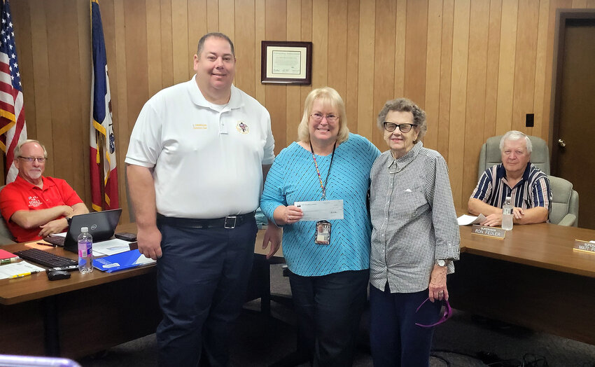 Lee County Health Department Administrator Michele Ross stands with Lee County EMS Assistant Director Jason Dinwiddie, left, and Ruth Taylor right, showing a check for $250,000 for the new Meller Family Health Center. The check was a donation from the North Lee Community Foundation. Taylor was one of the contributors the foundation funds.