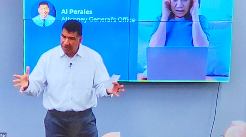 Al Perales, an investigator with the Iowa Attorney General's office, talks via livestream with seniors at Two Rivers Bank locations across Iowa Wednesday night.