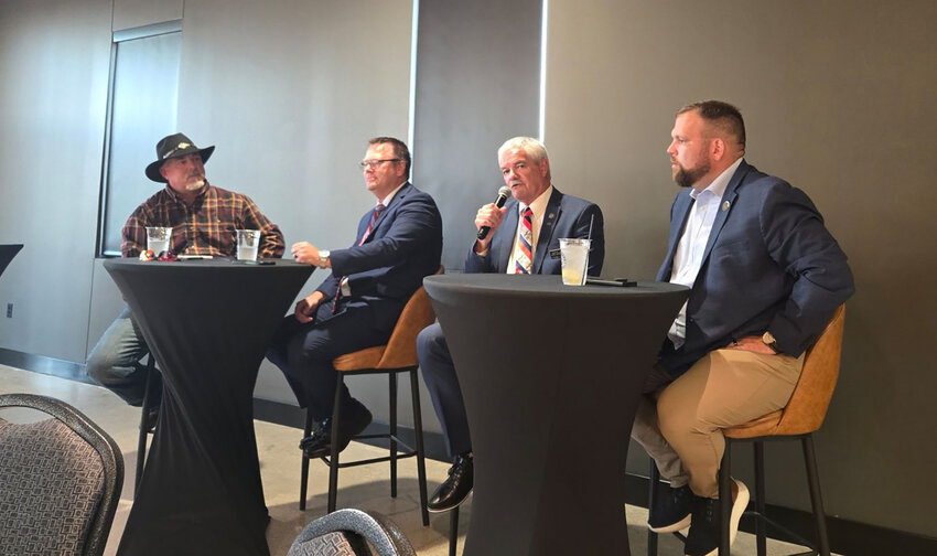 State Rep. Martin Graber, center, talks to a crowd at Turnwater Bar and Grill in Fort Madison during a Republican election forum Thursday night. With Graber, from right to left, are moderator Darin Ranck, State Sen. Jeff Reichman, and State Rep. Matt Rinker.