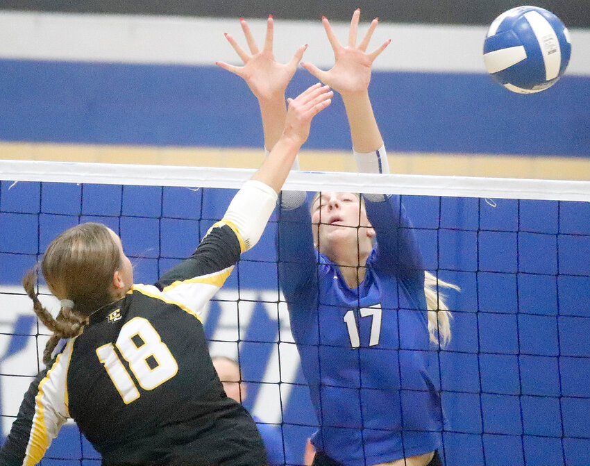 Central Lee's Taylor Jones attempts a kill at the net with Holy Trinity's Presley Myers defending. The Lady Crusaders won in four sets Thursday night in Fort Madison.