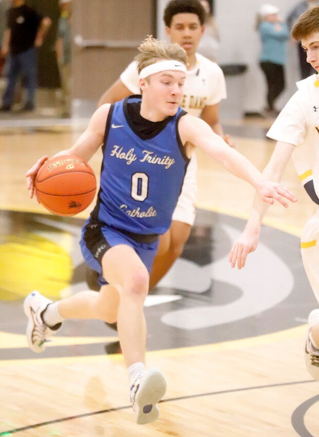 Holy Trinity Catholic guard Adam Sobczak races up the floor with the ball in the third quarter of Tuesday's 55-46 loss to Burlington Notre Dame at Central Lee.