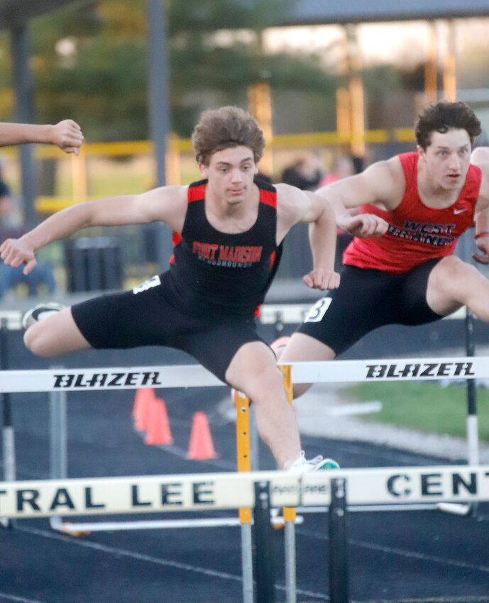 Fort Madison's Gavin Callahan clears the fourth hurdle in the boys' 110-hurdle event Monday night at the Hawk Relays at Central Lee. Callahan would get caught up by a hurdle and not place in the top five, but the Hounds took 2nd overall.